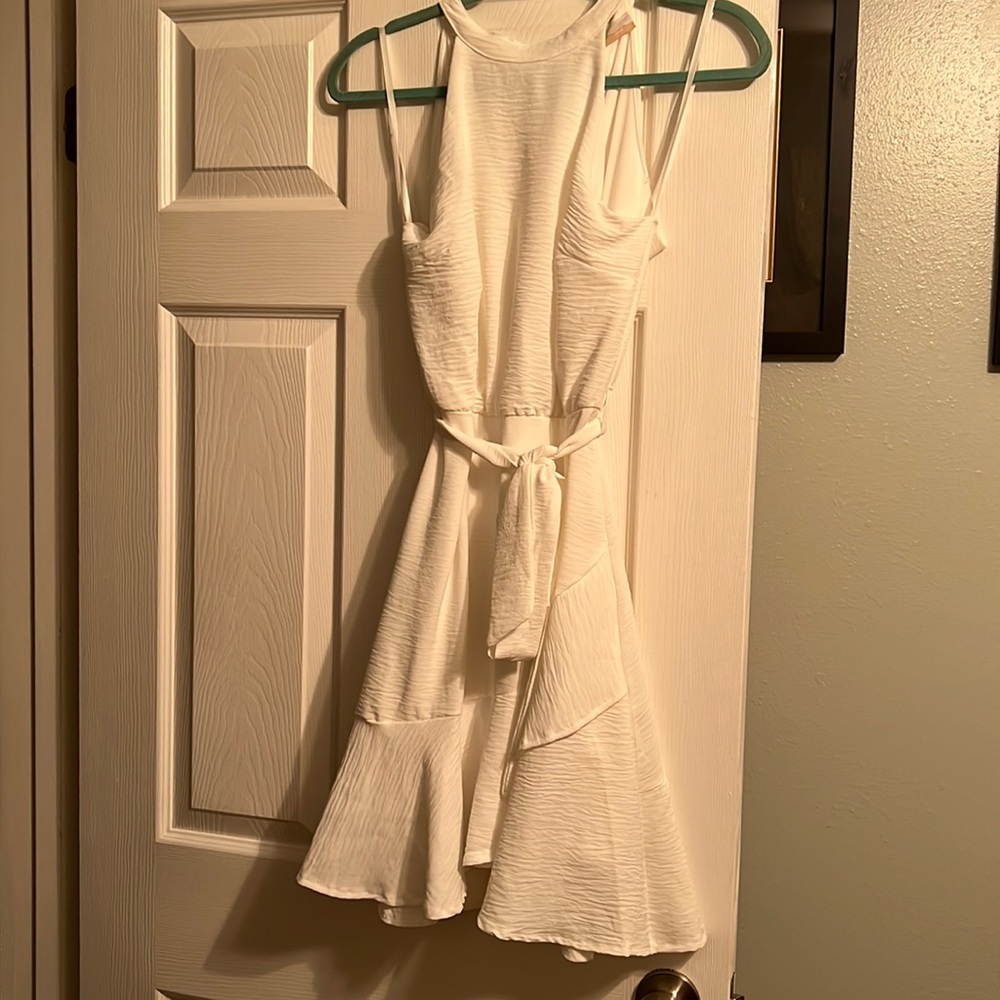 White flowy dress, open back.